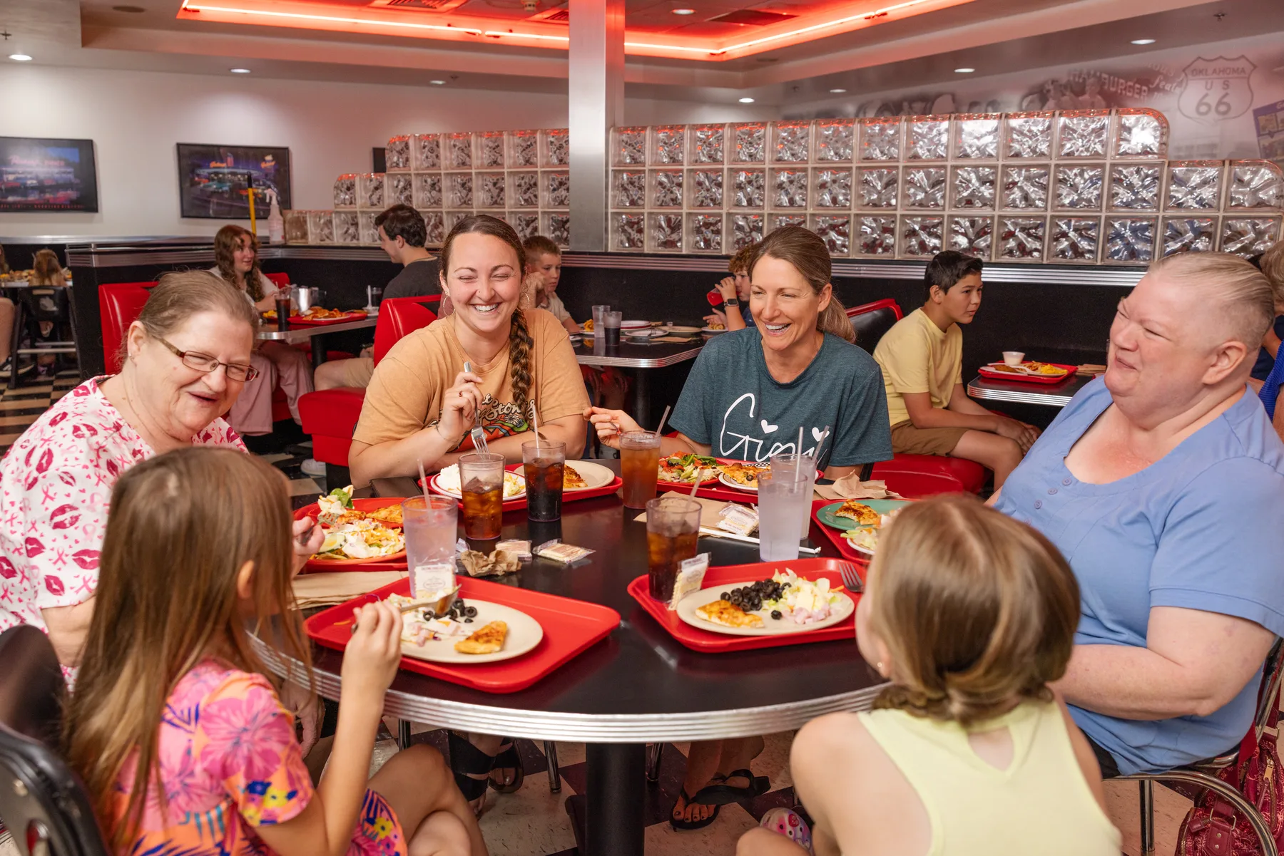 Families dining together inside an Incredible Pizza location